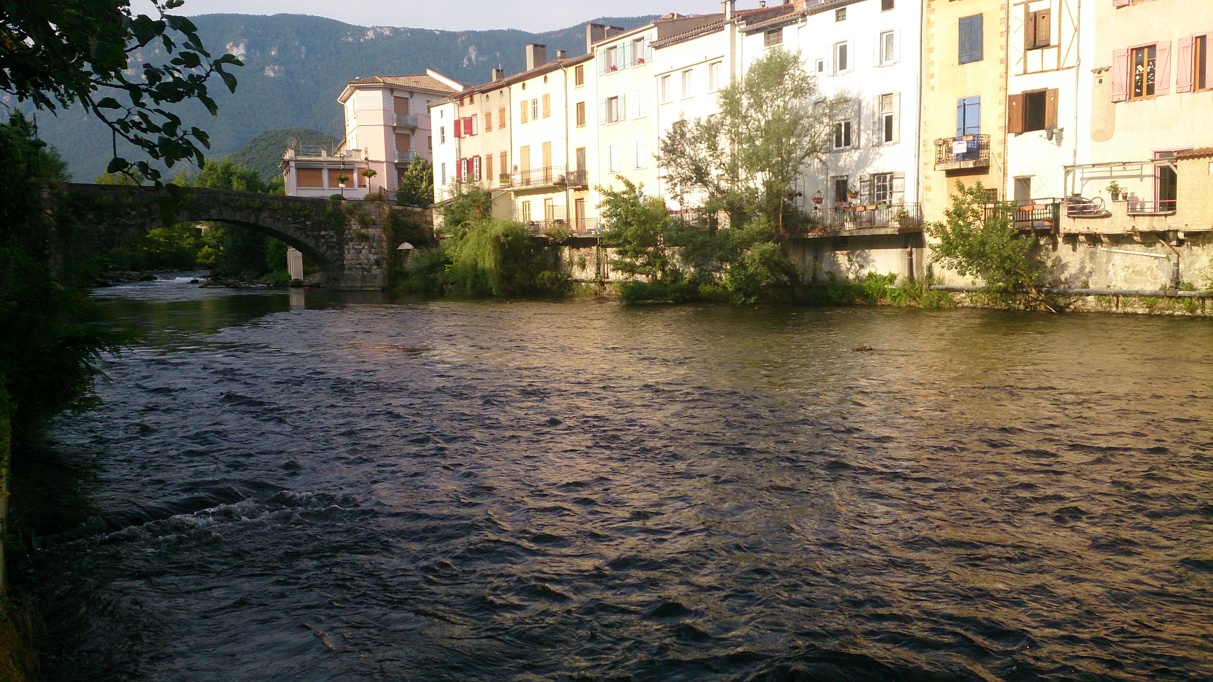 Morning sun on the river-side houses in Quillan from across the Aude